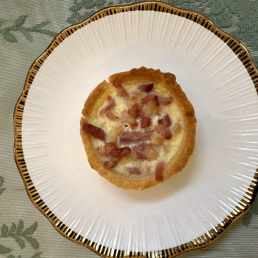 Quiche cu șuncă și brânză, servit pe farfurie